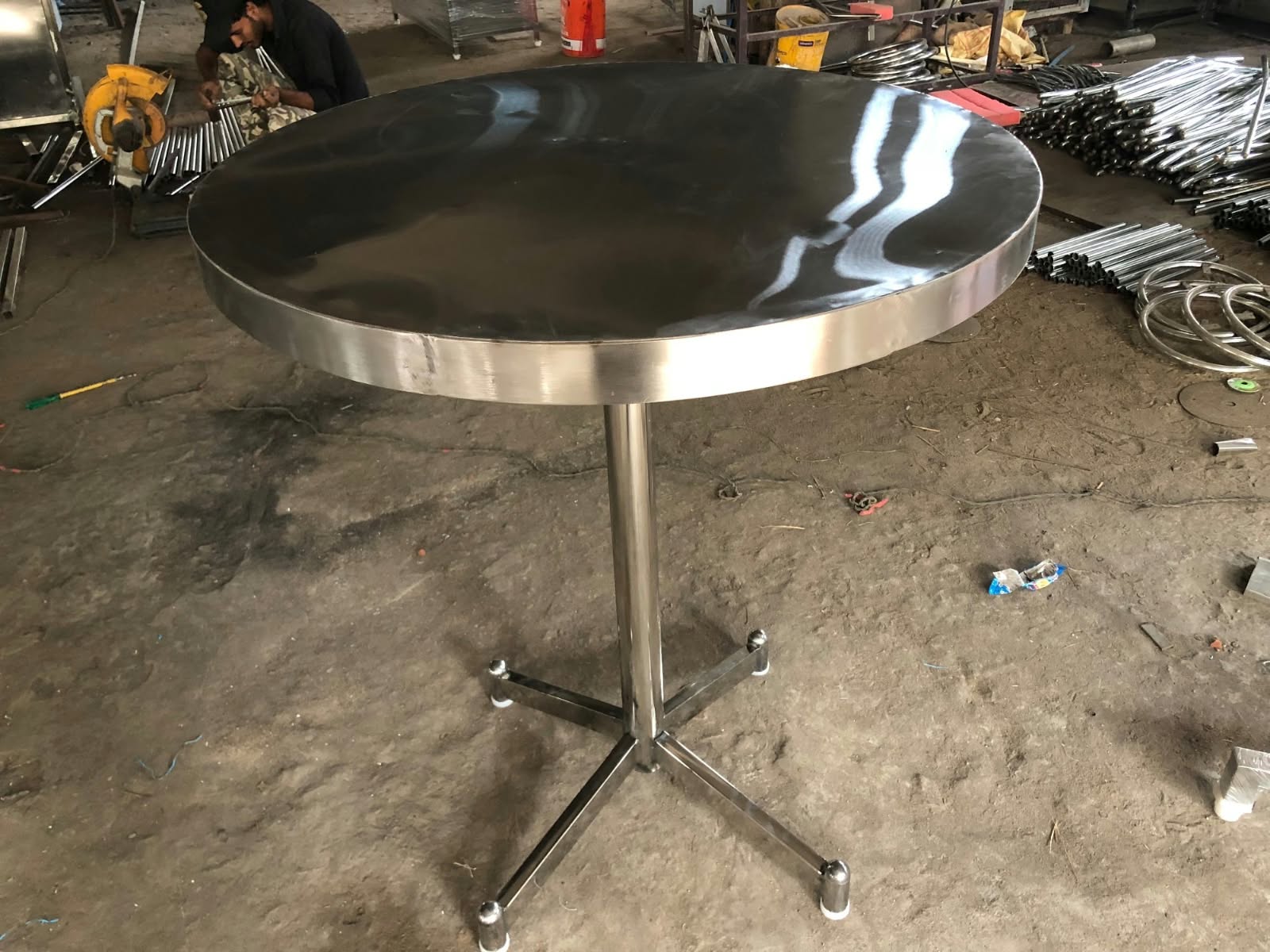 Round stainless-steel pedestal table